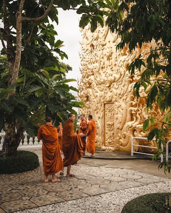Four Monks Beside Gold Statue