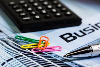 Four Paperclips Next to Silver Ink Pen and Black Calculator
