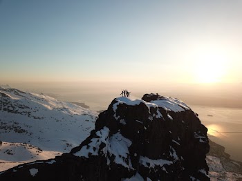 Four People Above Snow-covered Mountain Top