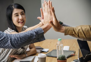 Four People Clapping Each Other