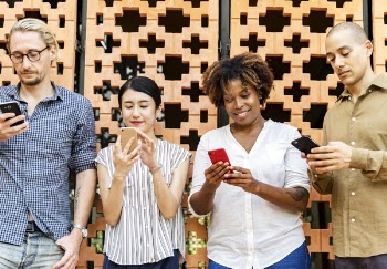 Four People Holding Mobile Phones
