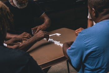 Four People Playing Domino
