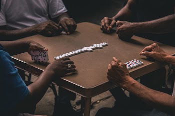 Four People Playing Dominoes