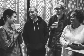 Four People Smiling Grayscale Photo
