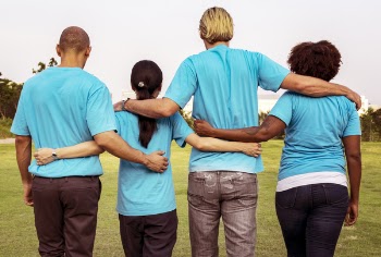 Four People Wearing Blue Crew-neck T-shirts