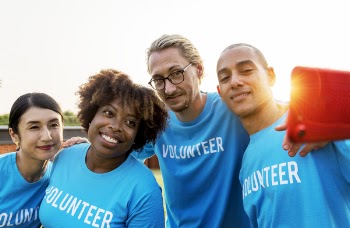 Four People Wearing the Same Blue-and-white Shirt Photography