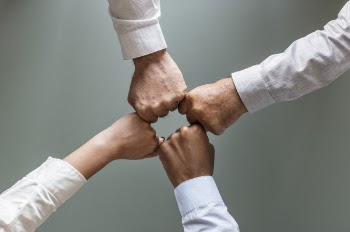 Four Person Hands in White Dress Shirts