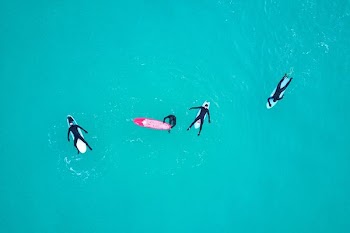 four person on body of water