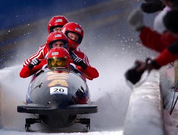 Four Person Riding on Snow Mobile