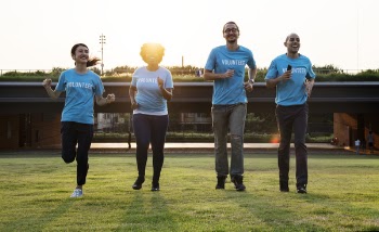 Four Person Running Green Grass Field