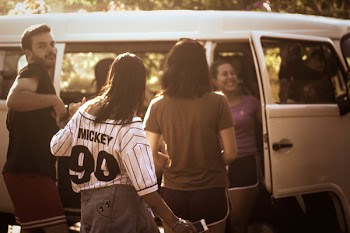 Four Person Standing Beside Van