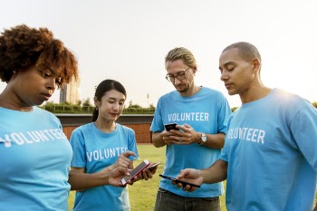 Four Person Wearing Blue Volunteer Crew-neck T-shirts