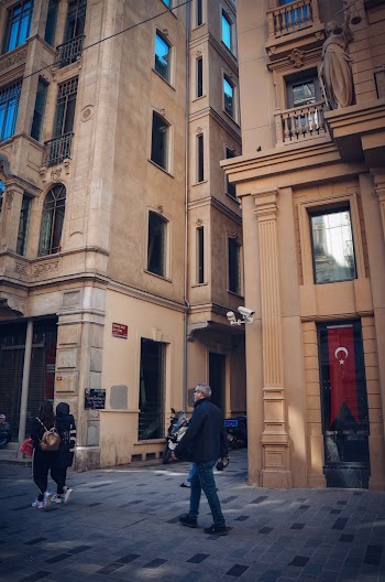 Four Persons Walking Beside Buildings