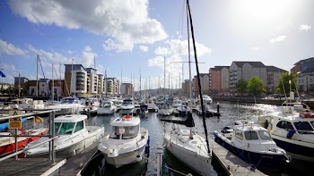 Four White Motorboats on Body of Water