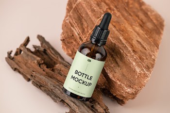Free Dropper Bottle on Stone Mockup