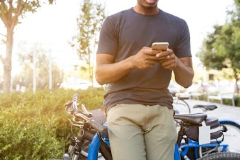 Free Photo of black man, outside, mobile phone