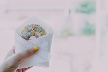 Free Photo of donut, sprinkles, hand