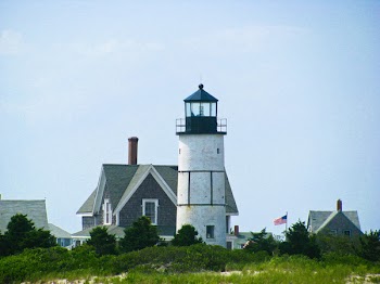 Free Photo of lighthouse, houses, flag