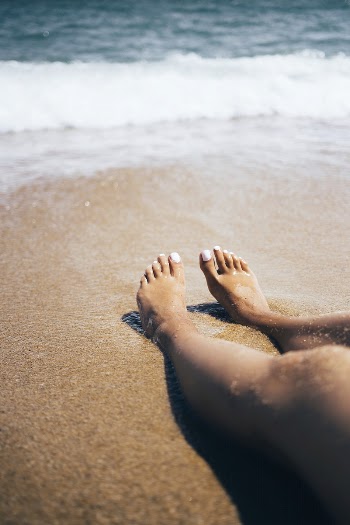 Free wave touching woman feet | Free Photo - rawpixel