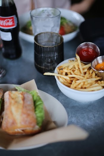 French Fries and Clear Glass Cup on Top of Table