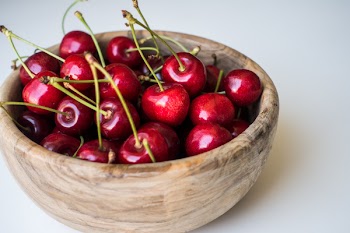 Fresh cherries in a wooden bowl 