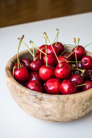 Fresh cherries in a wooden bowl 