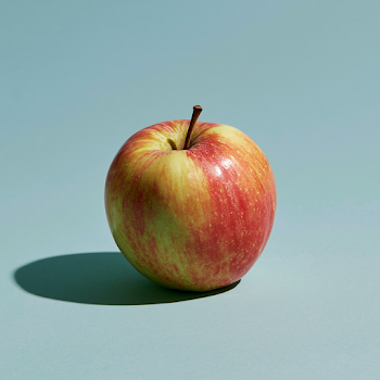 Fresh Red Apple on a Blue Background