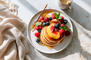 Fresh Summer Breakfast with Fluffy Pancakes and Berries