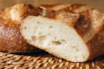 Freshly baked french baguette photographed in warm, afternoon sunlight to emphasize the texture.  Close-up with shallow dof