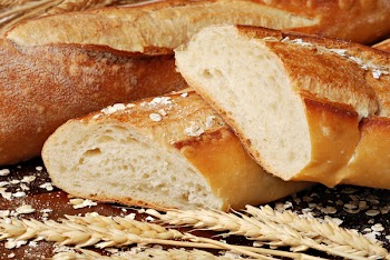 Freshly baked french baguettes with oats and wheat spikes.  Macro with shallow dof.