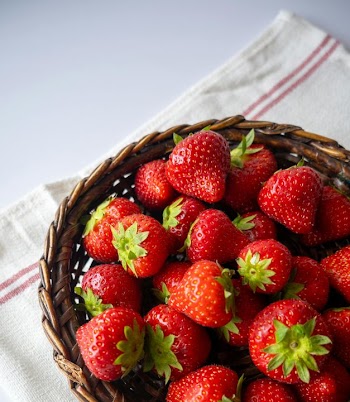 Freshly Harvested Strawberries in Woven Basket