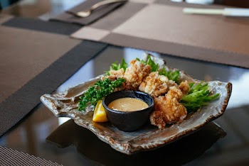 Fried Food With Brown Sauce On Plate