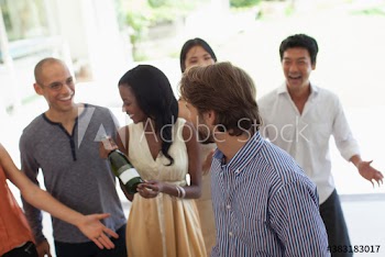 Friends enjoying wine at social gathering