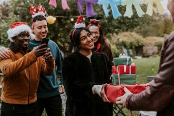 Friends exchanging Christmas gifts  | Free Photo - rawpixel