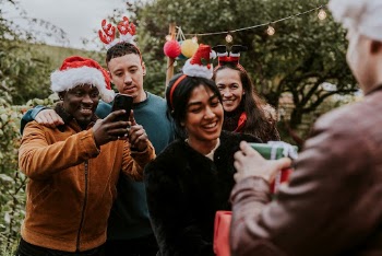 Friends exchanging Christmas gifts | Free Photo - rawpixel