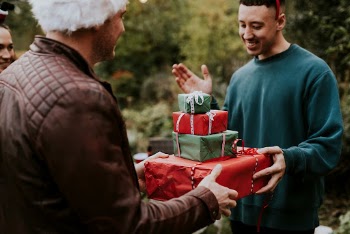 Friends exchanging Christmas gifts | Free Photo - rawpixel
