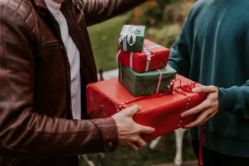 Friends exchanging Christmas gifts | Free Photo - rawpixel