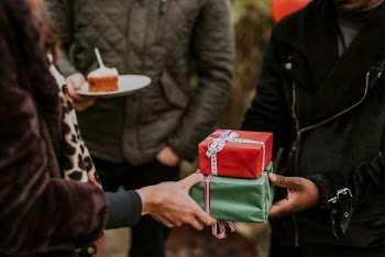 Friends exchanging gifts at a Christmas | Free Photo - rawpixel