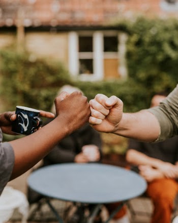 Friends fist bumping at a party | Free Photo - rawpixel