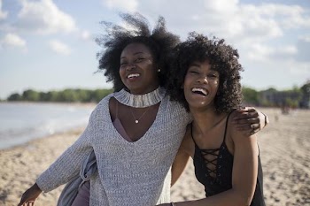 Friends Laughing On Beach
