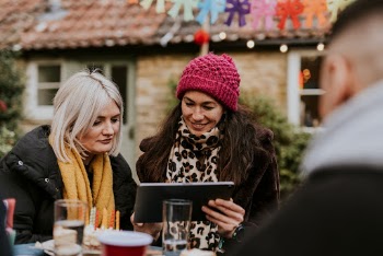Friends looking at a tablet | Free Photo - rawpixel