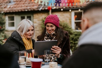 Friends looking at a tablet | Free Photo - rawpixel