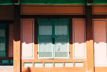 Front Of A House With Green Wooden Window 