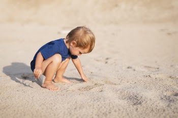 Front view little boy at beach playing Free Photo