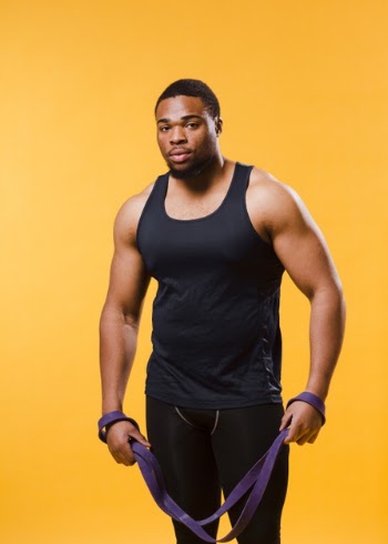 Front view of athletic man in gym outfit with resistance band Free Photo