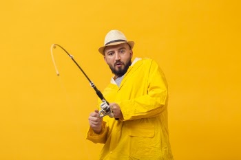 Front view of fisherman having a hard time with the fishing rod Free Photo