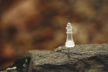 Frosted Glass Bishop Chess Piece on Rock