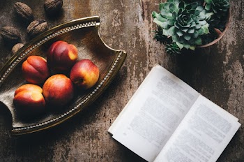 Fruits On Tray Beside Book And Potted Plant