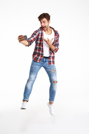 Full length portrait of a joyful happy man Free Photo