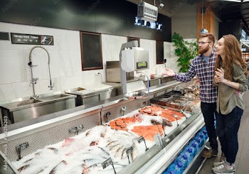 Full length portrait of couple choosing fish